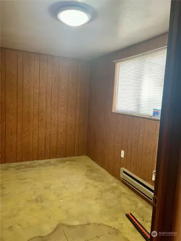 a bedroom with a refrigerator and a sink