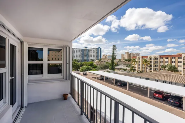 a bedroom with a large bed and a large window
