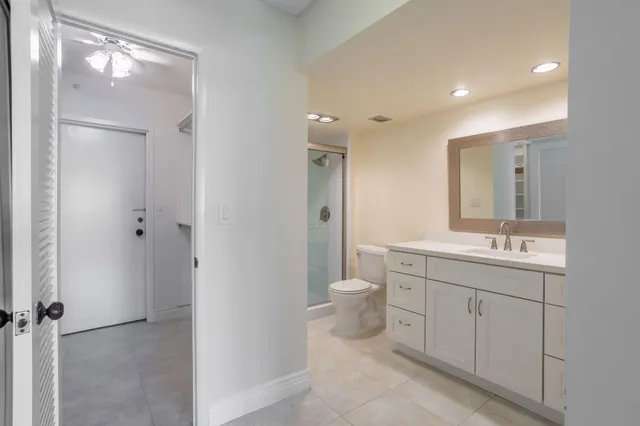 a large living room with stainless steel appliances lots of furniture and wooden floors