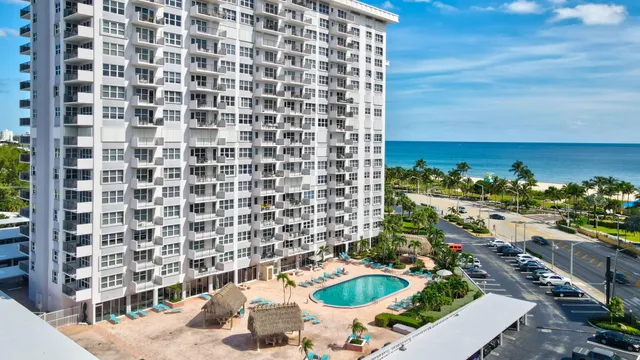a living room with a large bed and a large window with outer view