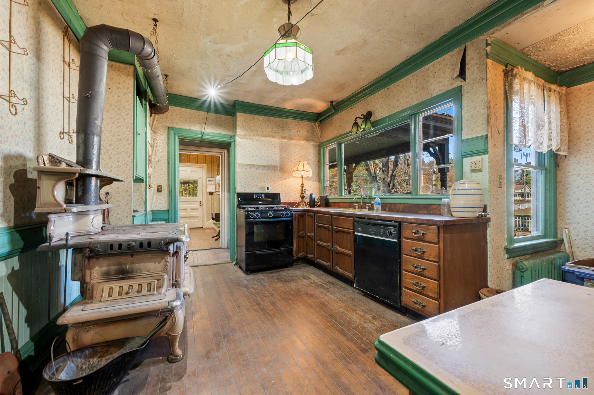 124 River Road Willington, CT 06279 - Photo 21 of 40 a kitchen with stainless steel appliances granite countertop a stove a sink dishwasher and a fireplace with wooden floor