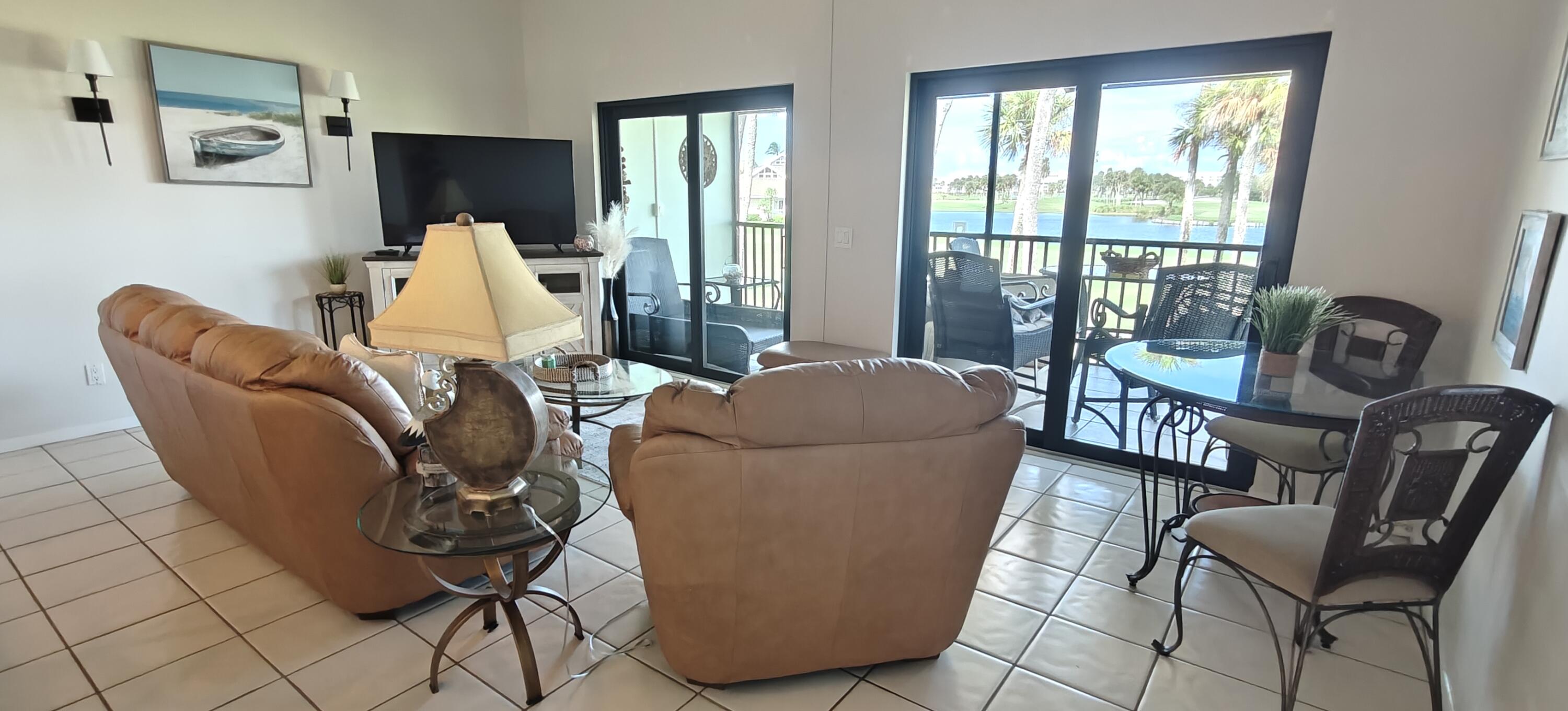 233 Northeast Edgewater Drive, Unit 203 Stuart, FL 34996 - Photo 13 of 30 a living room with furniture and a window