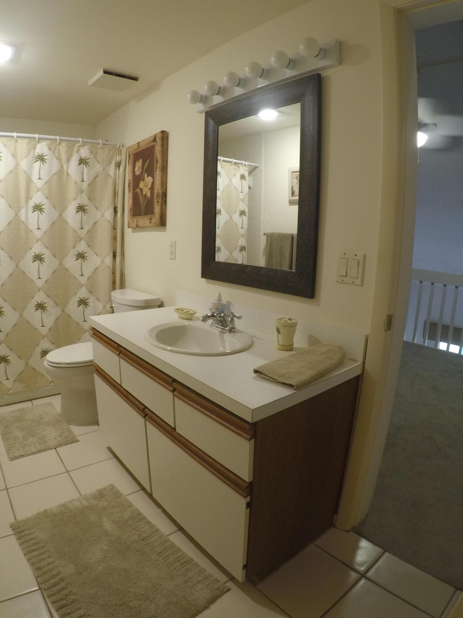 233 Northeast Edgewater Drive, Unit 203 Stuart, FL 34996 - Photo 21 of 30 a bathroom with a sink and a mirror