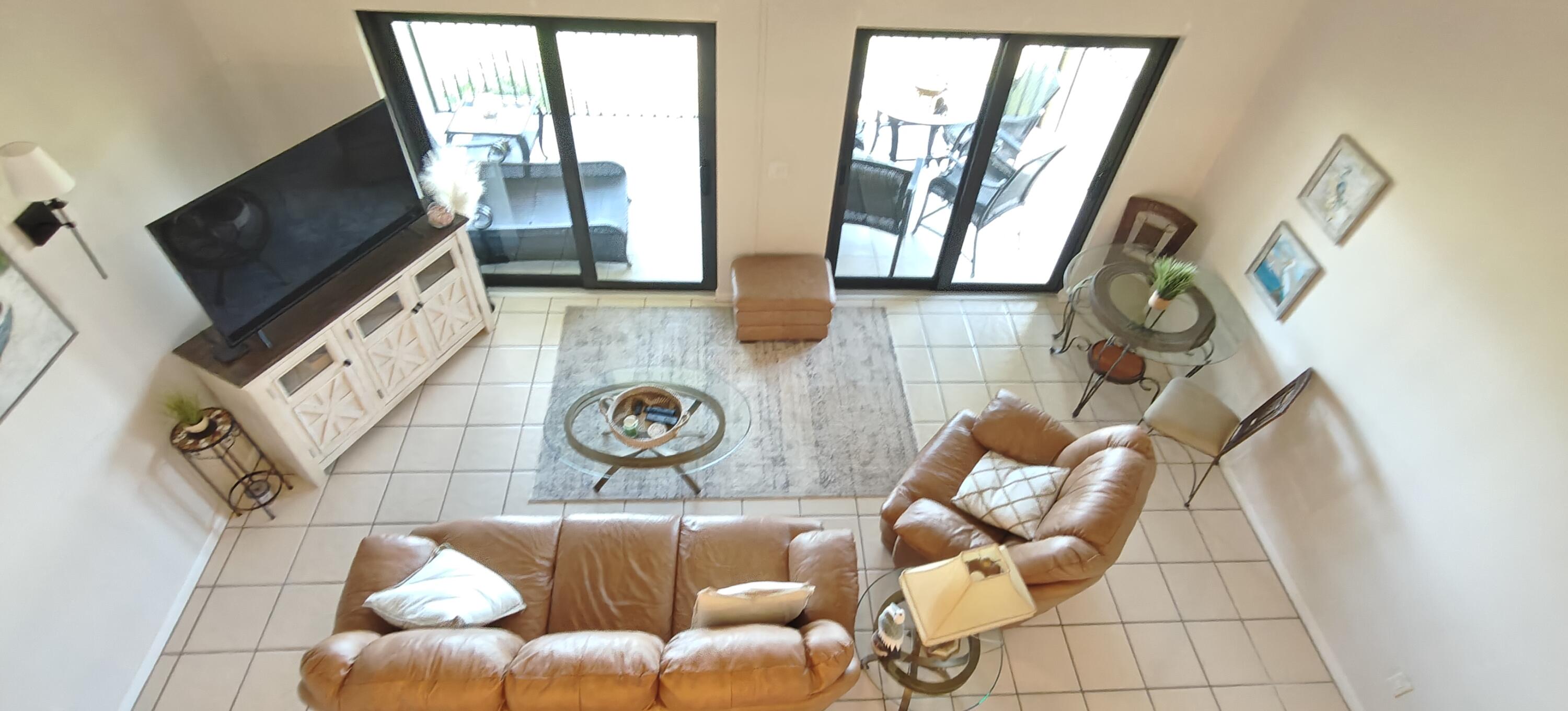 233 Northeast Edgewater Drive, Unit 203 Stuart, FL 34996 - Photo 22 of 30 a living room with furniture and a flat screen tv