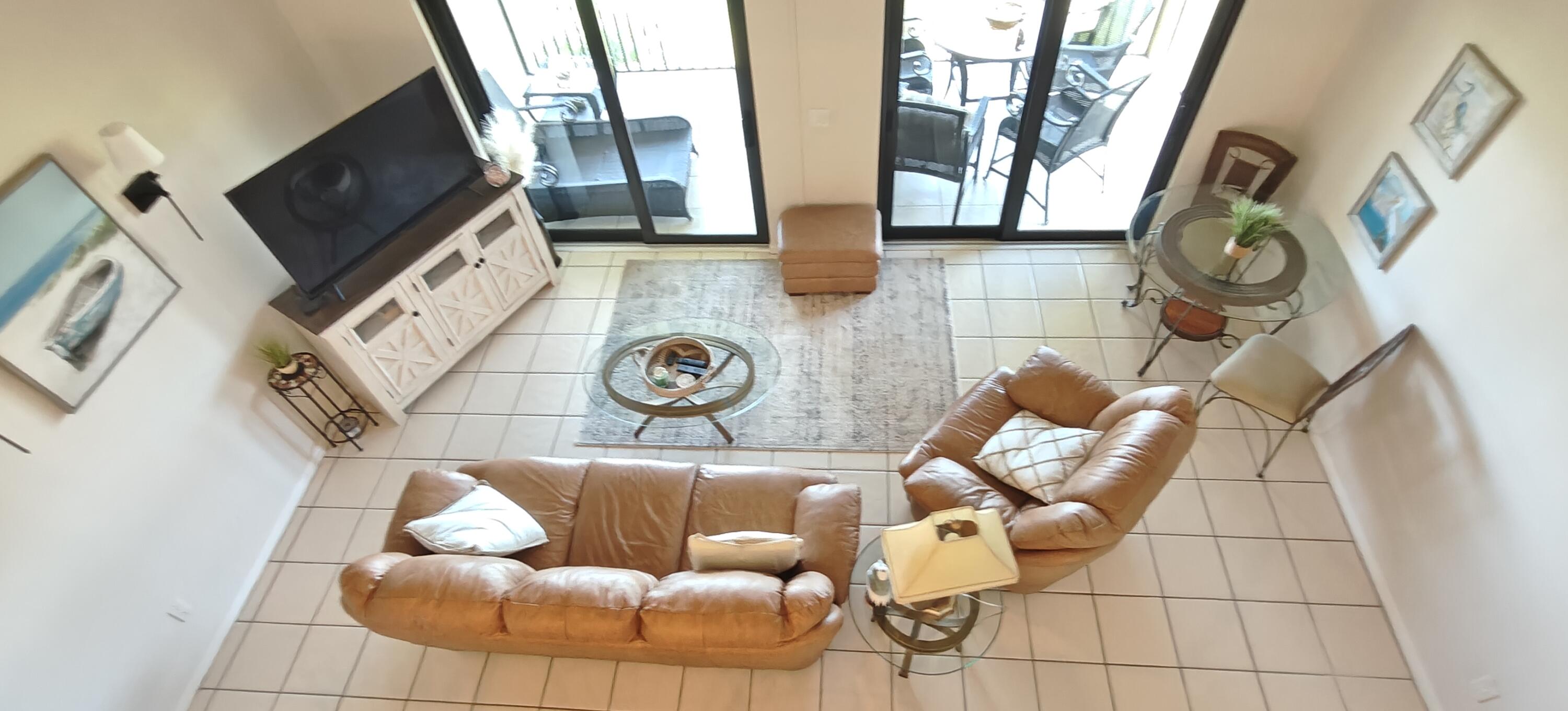 233 Northeast Edgewater Drive, Unit 203 Stuart, FL 34996 - Photo 23 of 30 a living room with couch and a fireplace