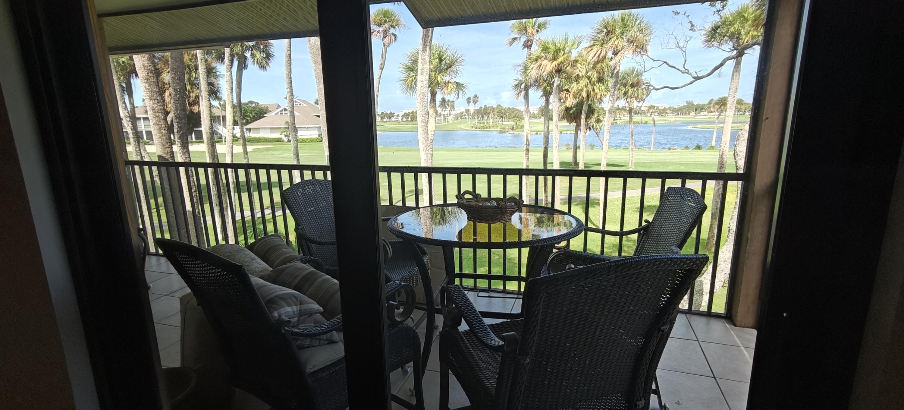 233 Northeast Edgewater Drive, Unit 203 Stuart, FL 34996 - Photo 25 of 30 a view of a city from a dining room with large windows
