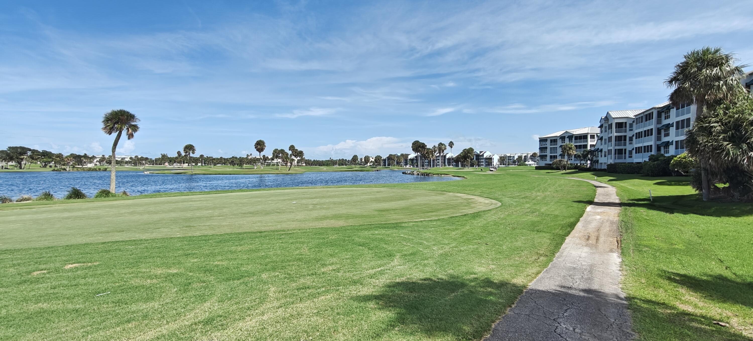 233 Northeast Edgewater Drive, Unit 203 Stuart, FL 34996 - Photo 5 of 30 a view of a park with a big yard and potted plants