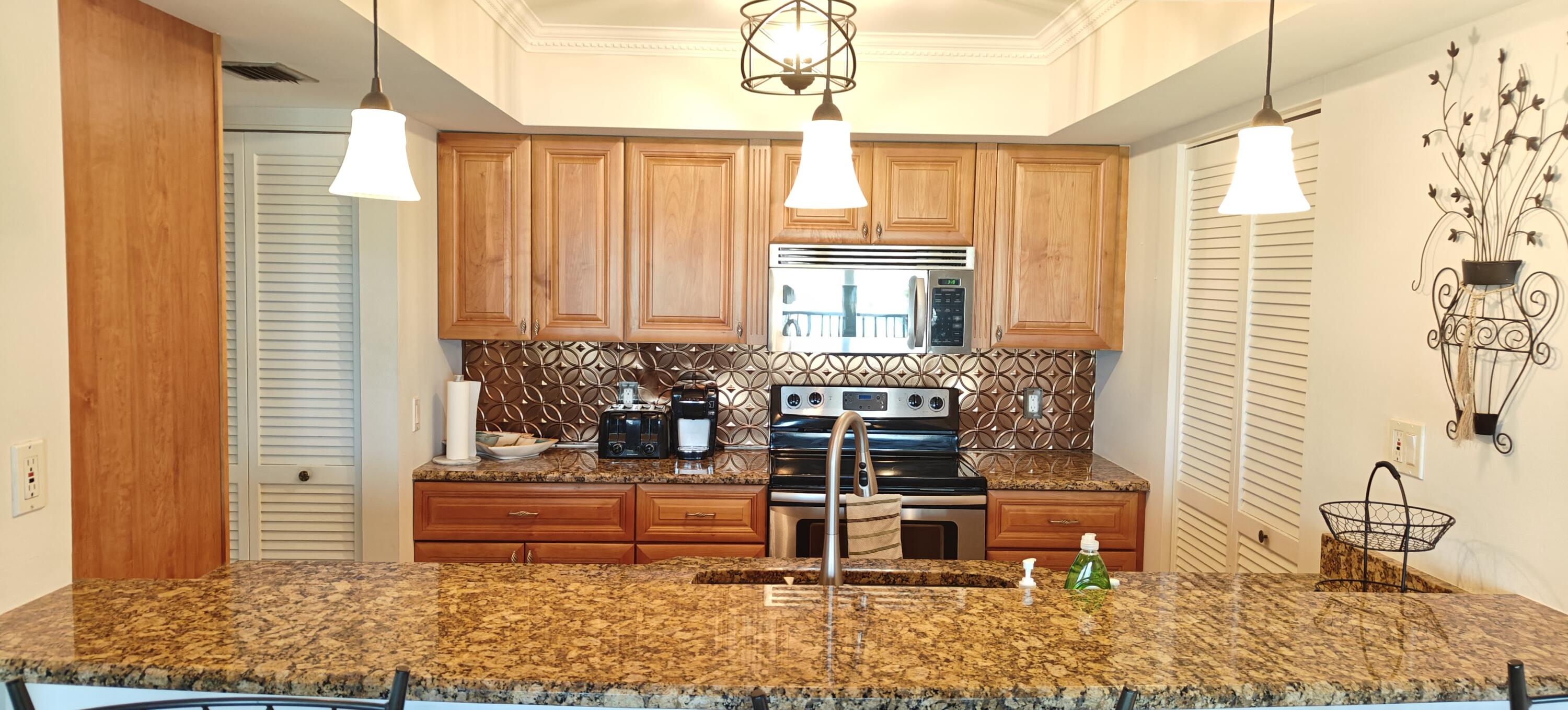 233 Northeast Edgewater Drive, Unit 203 Stuart, FL 34996 - Photo 10 of 30 a bathroom with a sink and a window