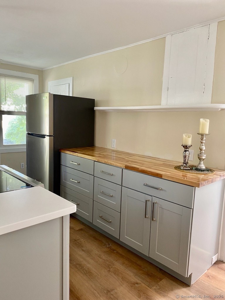 831 Boston Post Road Madison, CT 06443 - Photo 3 of 13 a kitchen with a refrigerator sink and cabinets