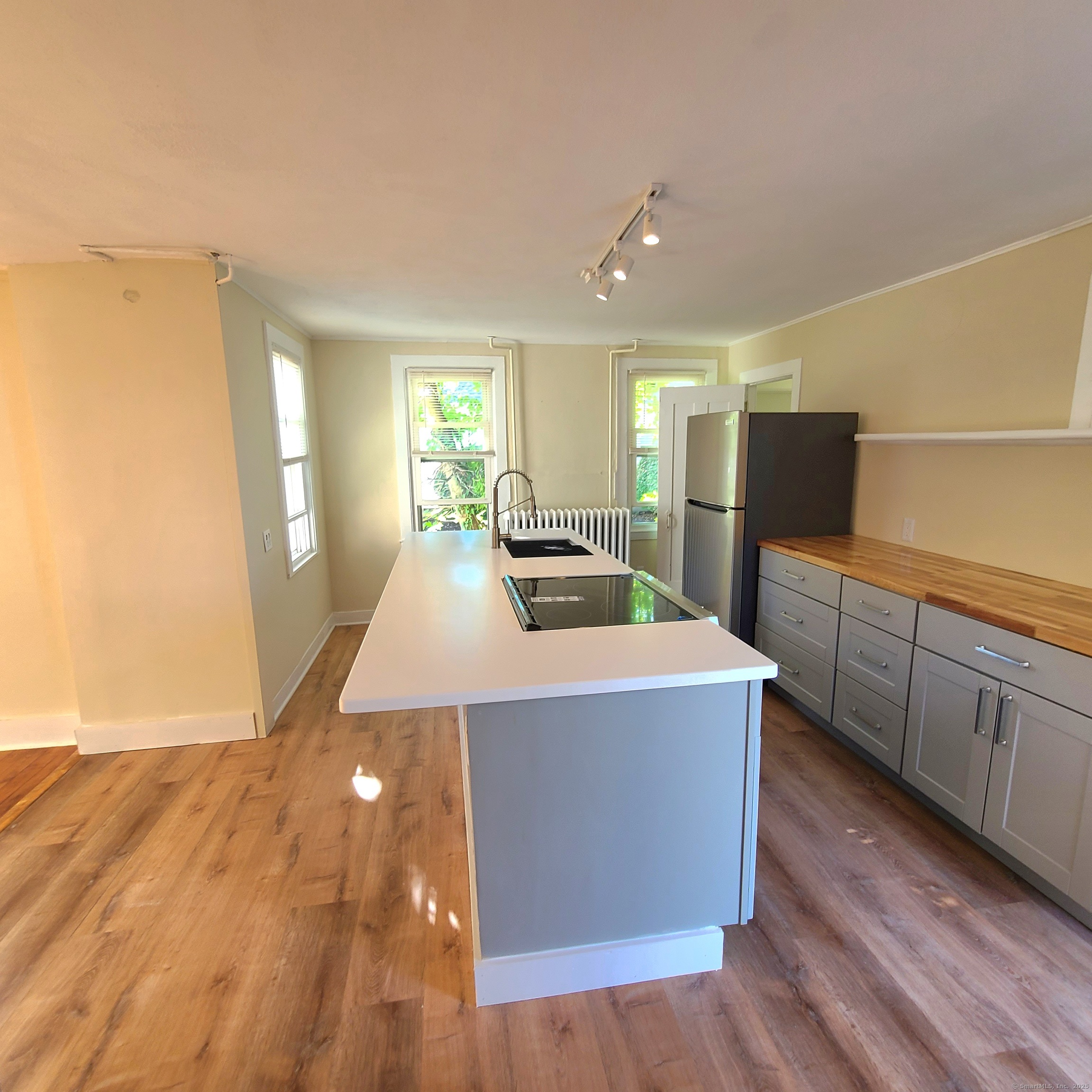 831 Boston Post Road Madison, CT 06443 - Photo 5 of 13 a large kitchen with cabinets wooden floor and stainless steel appliances