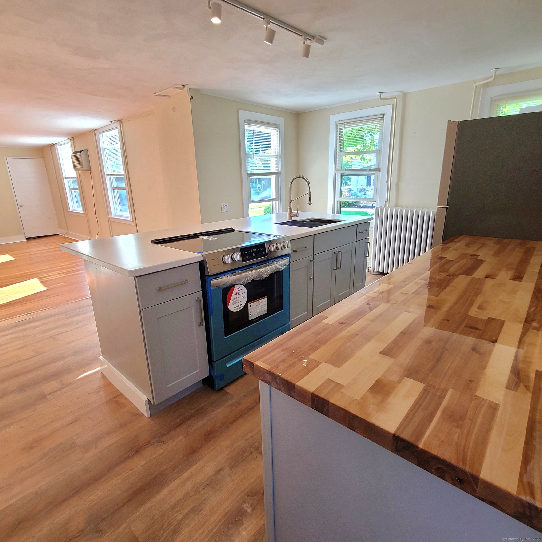831 Boston Post Road Madison, CT 06443 - Photo 6 of 13 a kitchen with stainless steel appliances kitchen island granite countertop a stove a sink and a wooden floors