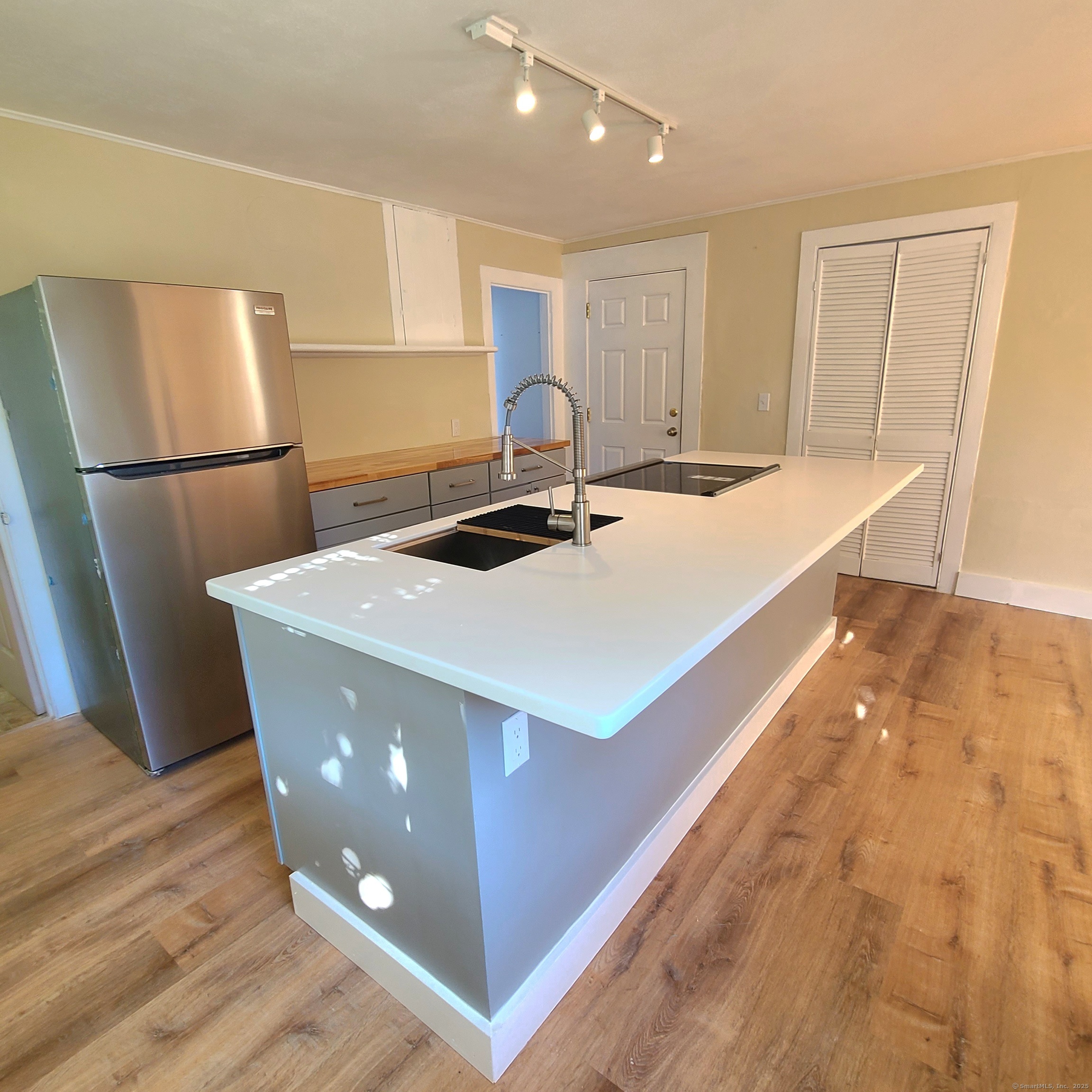831 Boston Post Road Madison, CT 06443 - Photo 7 of 13 a kitchen with stainless steel appliances a refrigerator sink and wooden cabinets
