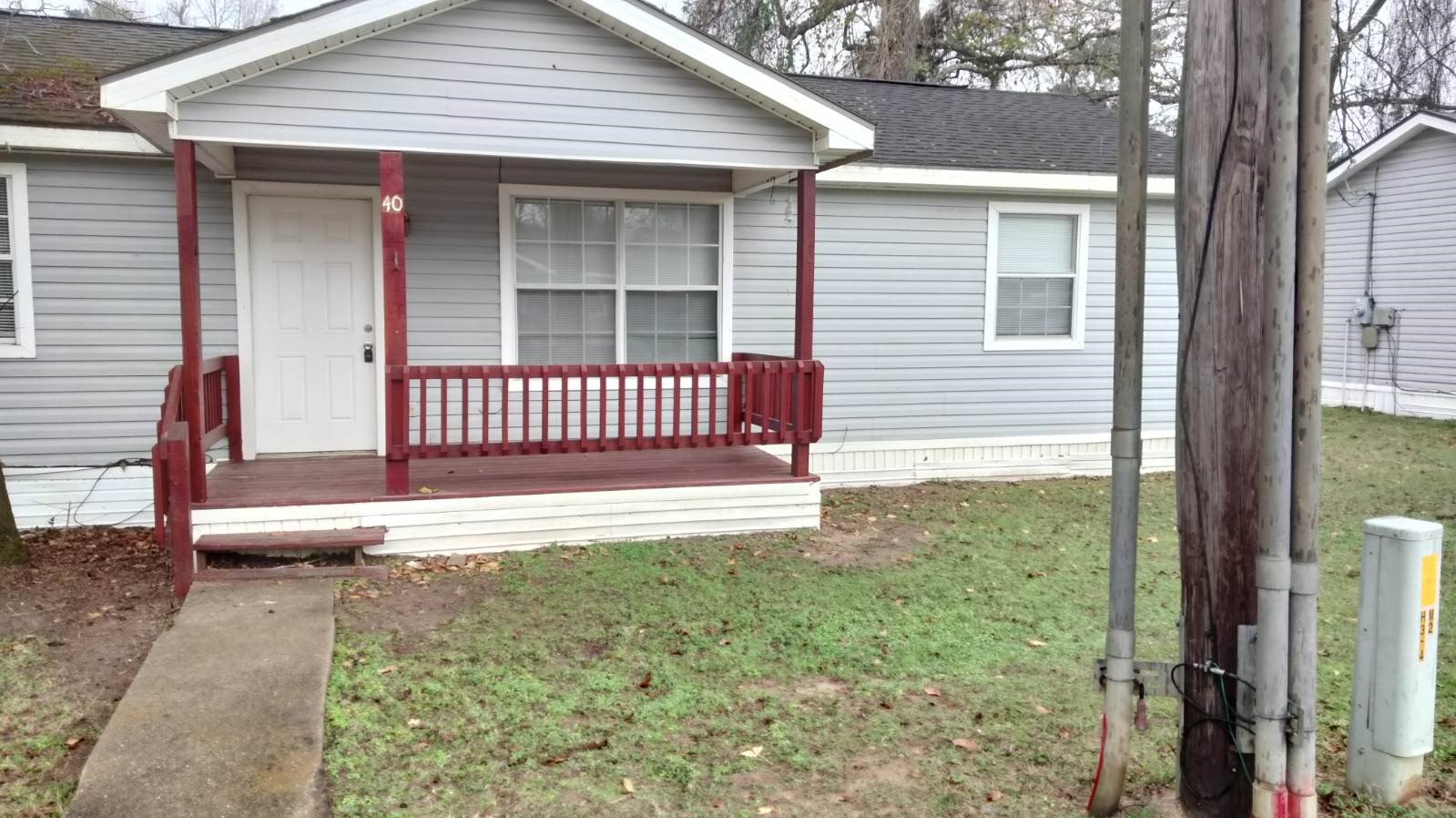 a view of a house with a wooden fence