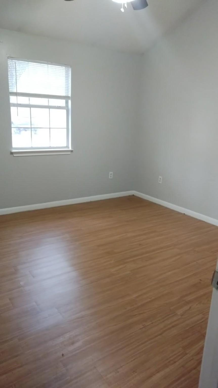 40 Sunset Ridge Drive Coldspring, TX 77331 - Photo 2 of 12 an empty room with wooden floor and windows