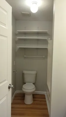 a bathroom with a toilet and a shower