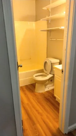 a bathroom with a toilet and a shower