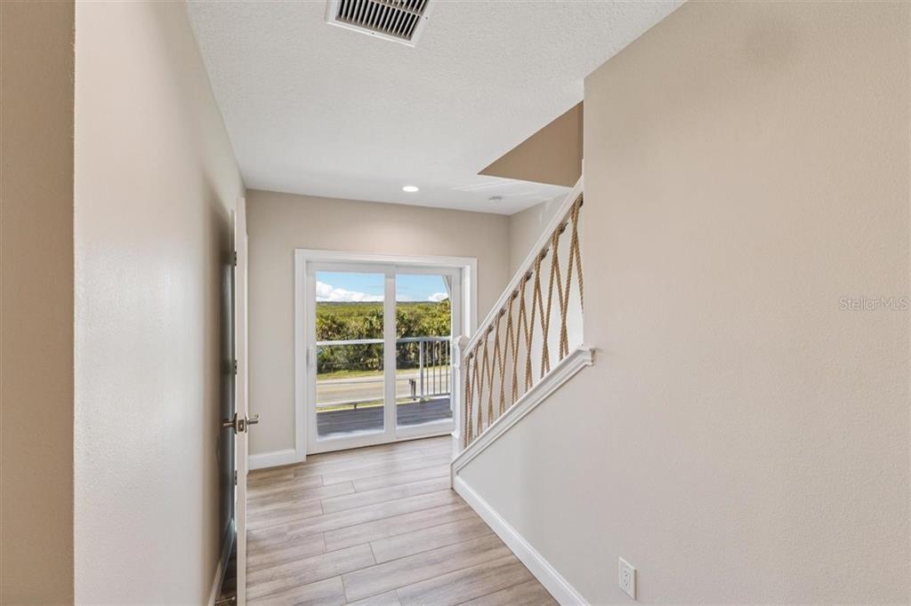 6191 Turtlemound Road New Smyrna Beach, FL 32169 - Photo 63 of 90 a view of an entryway with wooden floor