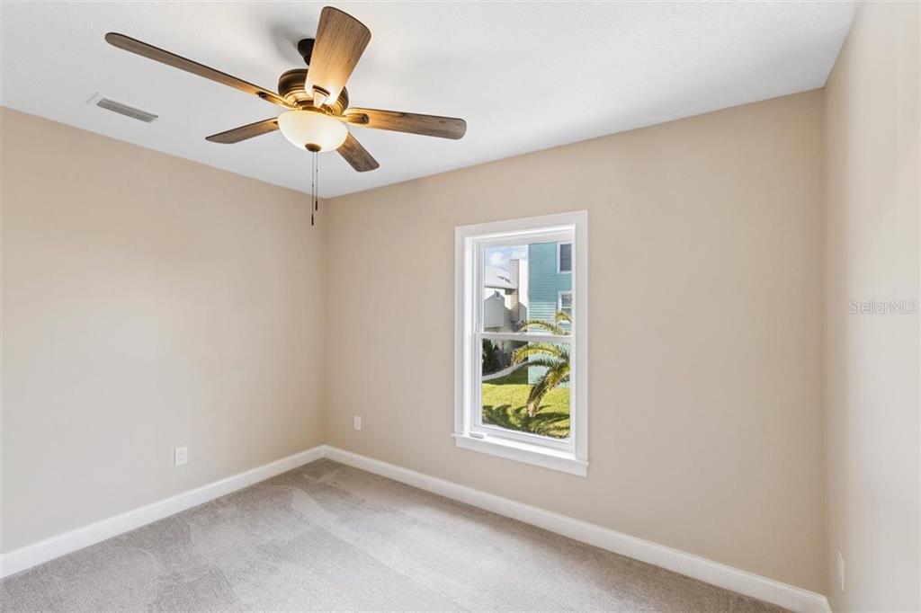 6191 Turtlemound Road New Smyrna Beach, FL 32169 - Photo 64 of 90 an empty room with window and outdoor view