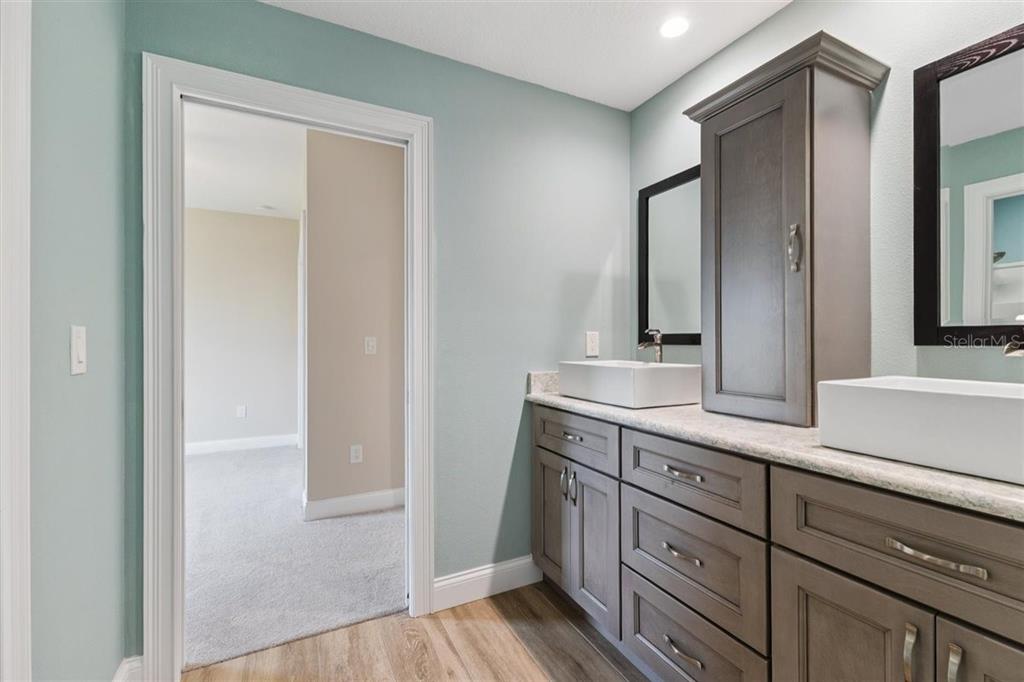 6191 Turtlemound Road New Smyrna Beach, FL 32169 - Photo 67 of 90 a bathroom with a sink and a mirror