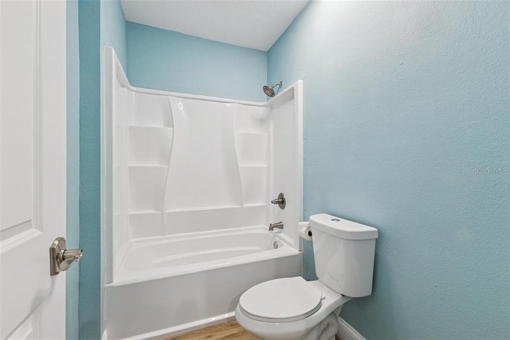 6191 Turtlemound Road New Smyrna Beach, FL 32169 - Photo 68 of 90 a white toilet sitting next to a bath tub