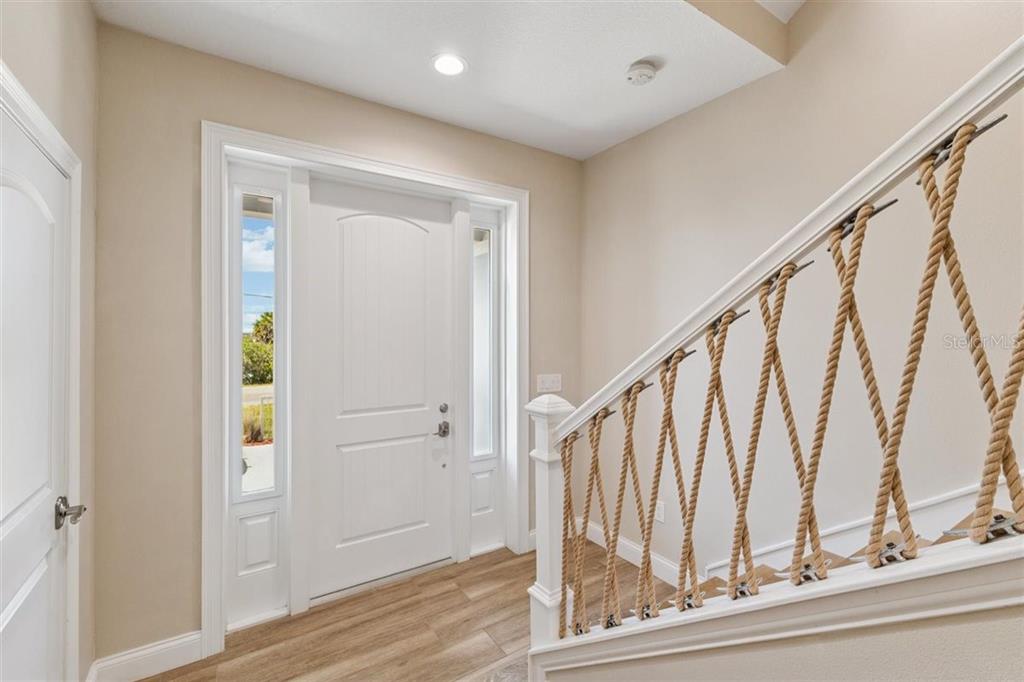6191 Turtlemound Road New Smyrna Beach, FL 32169 - Photo 9 of 90 a view of staircase with wooden floor and staircase