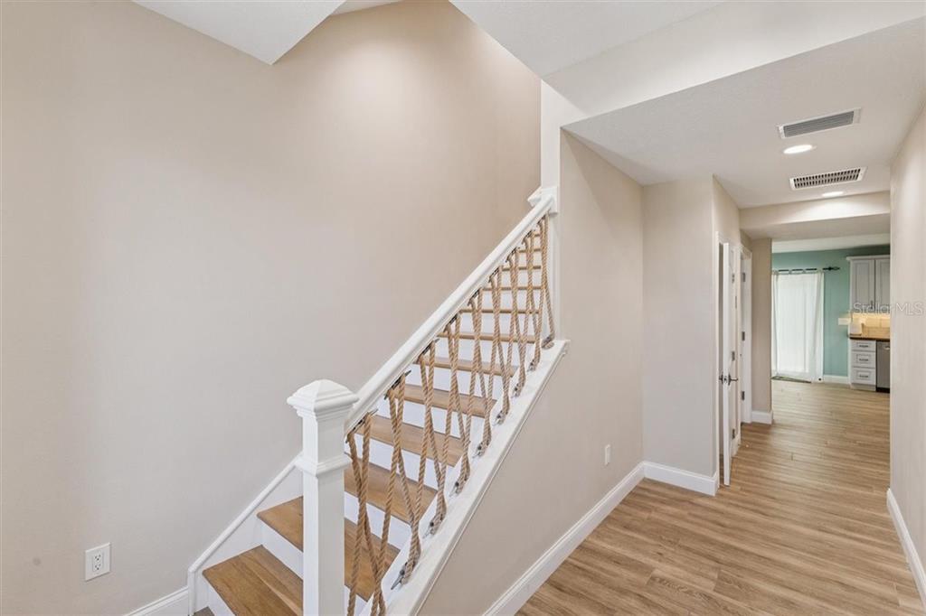 6191 Turtlemound Road New Smyrna Beach, FL 32169 - Photo 10 of 90 a view of a hallway with wooden floor and staircase