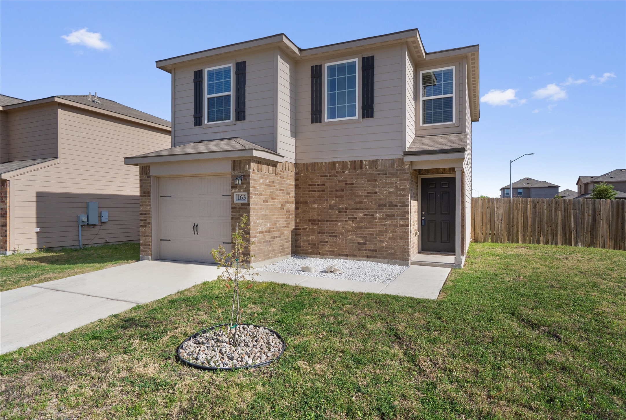 163 Niven Path, Unit 12K Jarrell, TX 76537 - Photo 1 of 31 a backyard of a house with table and chairs