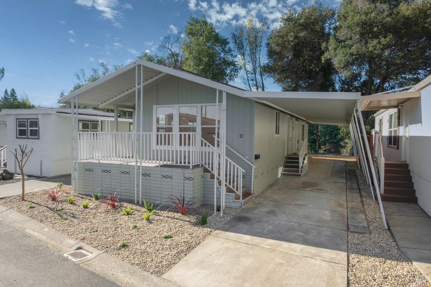 a view of a house with a yard and wooden fence