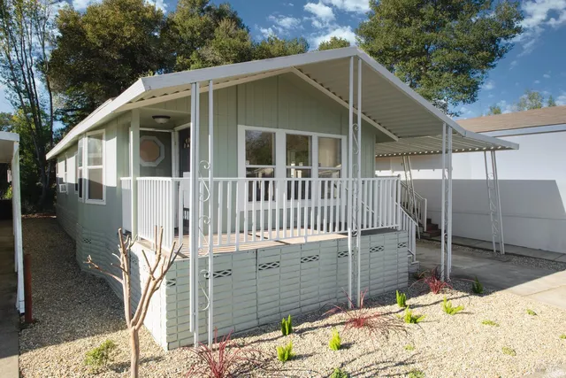 a view of a house with wooden fence