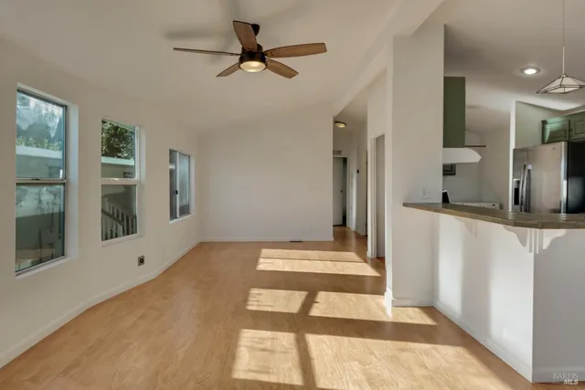 a kitchen with kitchen island a counter top space a sink stainless steel appliances and cabinets