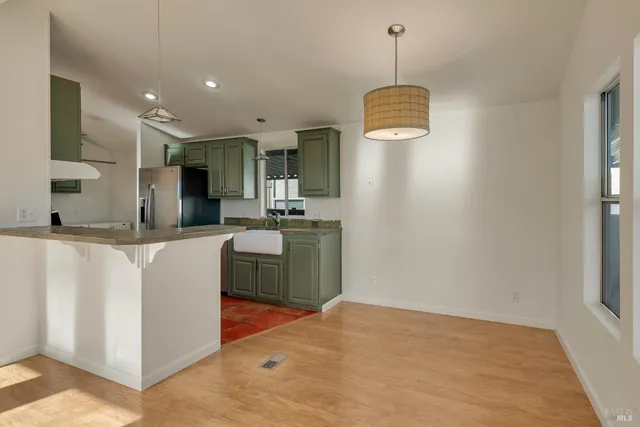 a kitchen with stainless steel appliances granite countertop a sink and a stove top oven