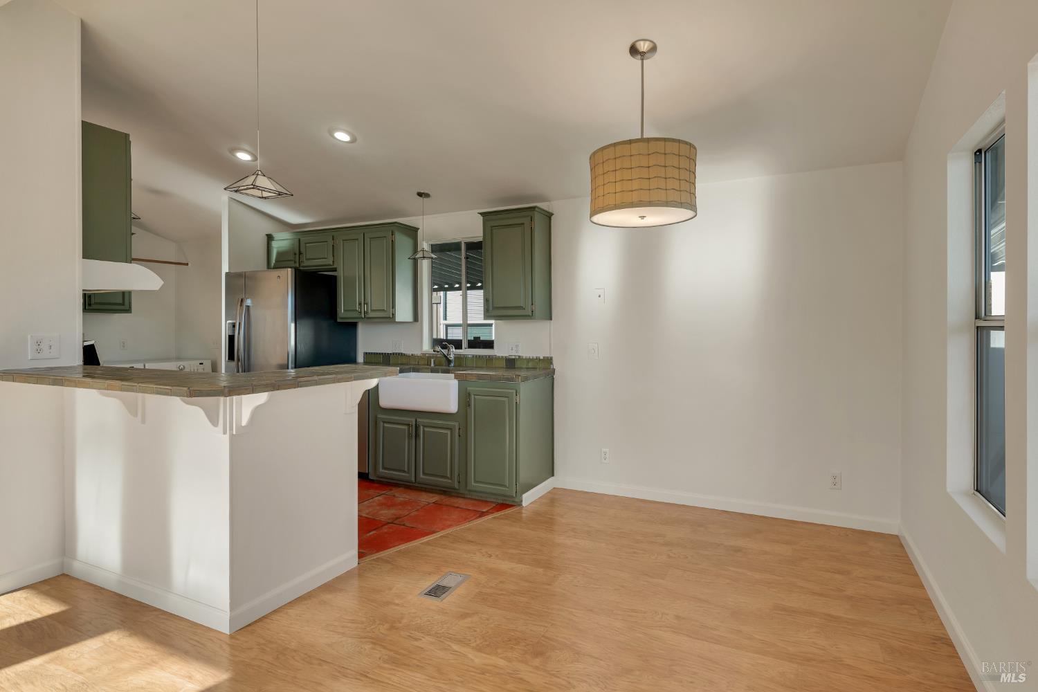 49 Ramon Street Sonoma, CA 95476 - Photo 6 of 39 a kitchen with kitchen island a counter top space a sink stainless steel appliances and cabinets