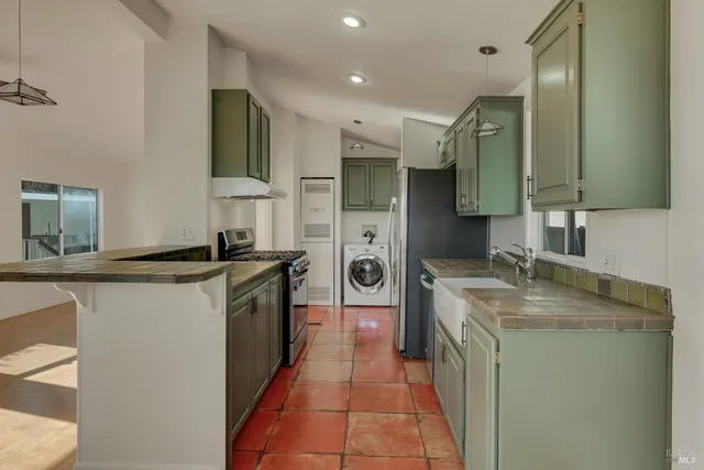 a kitchen with stainless steel appliances granite countertop a stove and a sink