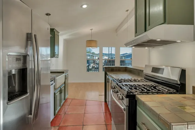 a kitchen with stainless steel appliances granite countertop a stove and a microwave