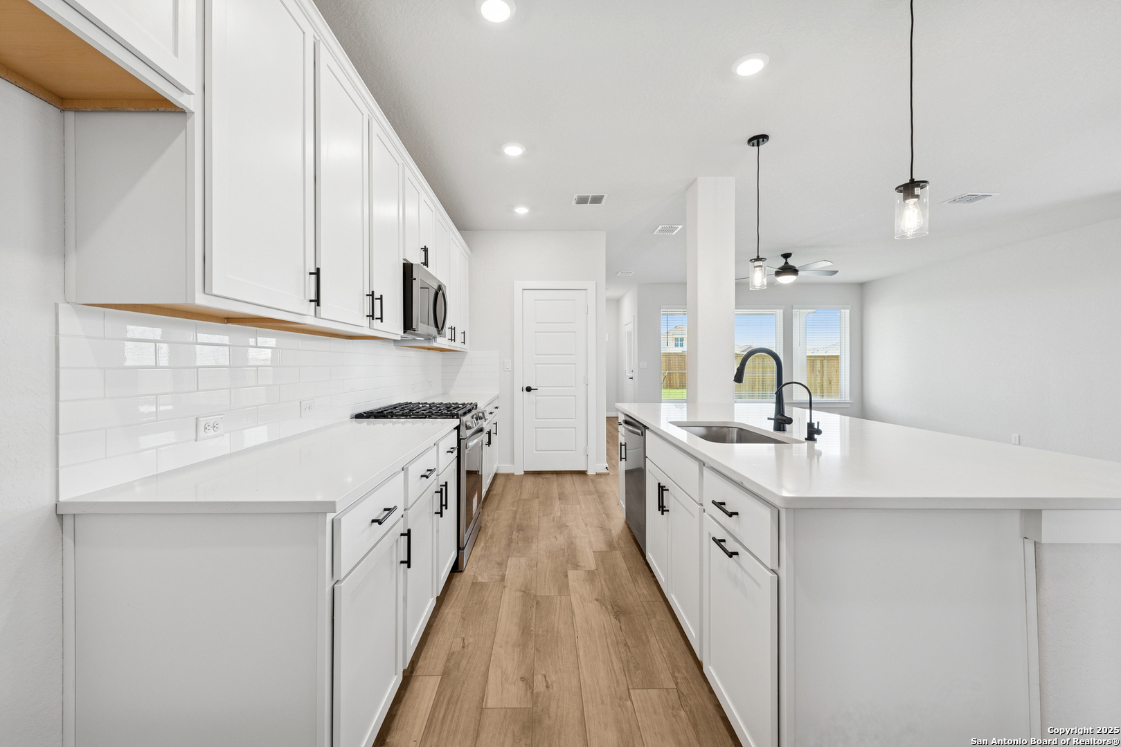 129 Radnor Road New Braunfels, TX 78130 - Photo 2 of 8 a large kitchen with stainless steel appliances kitchen island granite countertop a sink and cabinets