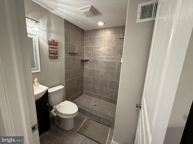 a bathroom with a toilet and a shower