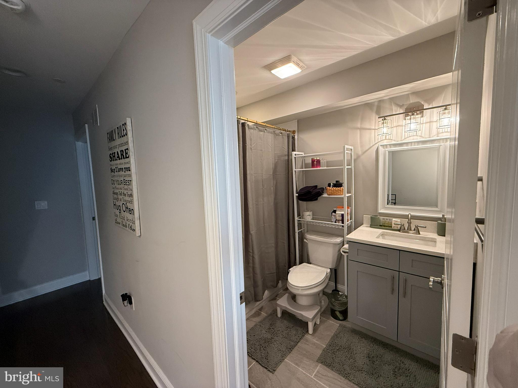 2131 North 10th Street Philadelphia, PA 19122 - Photo 14 of 18 a room with a toilet sink a mirror and vanity