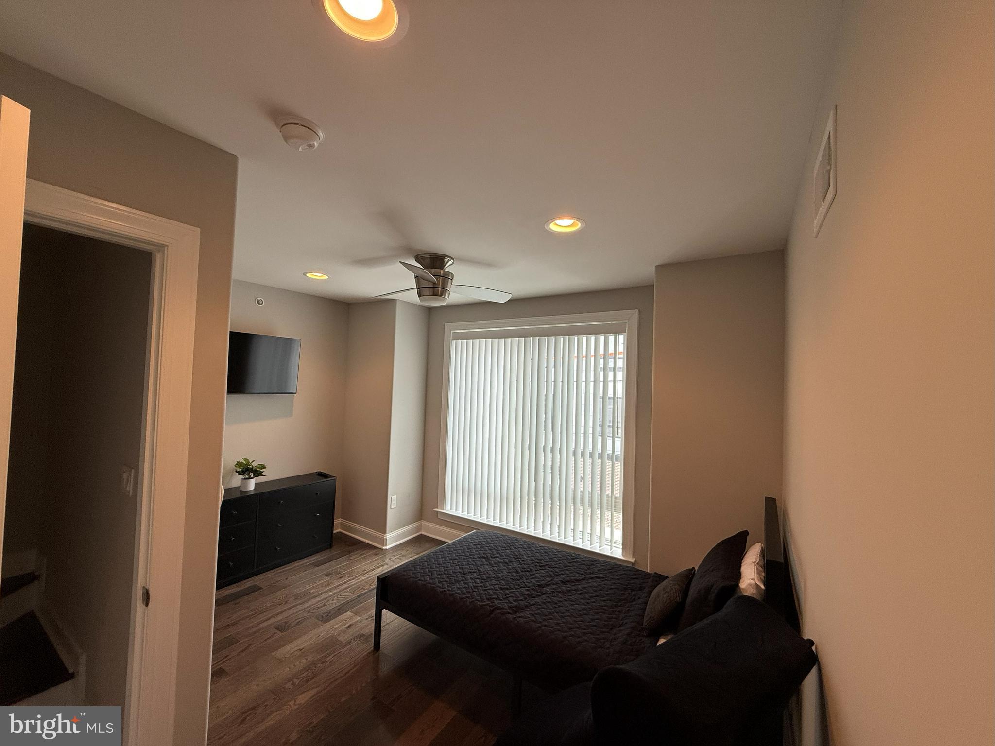 2131 North 10th Street Philadelphia, PA 19122 - Photo 15 of 18 a bedroom with a bed and wooden floor