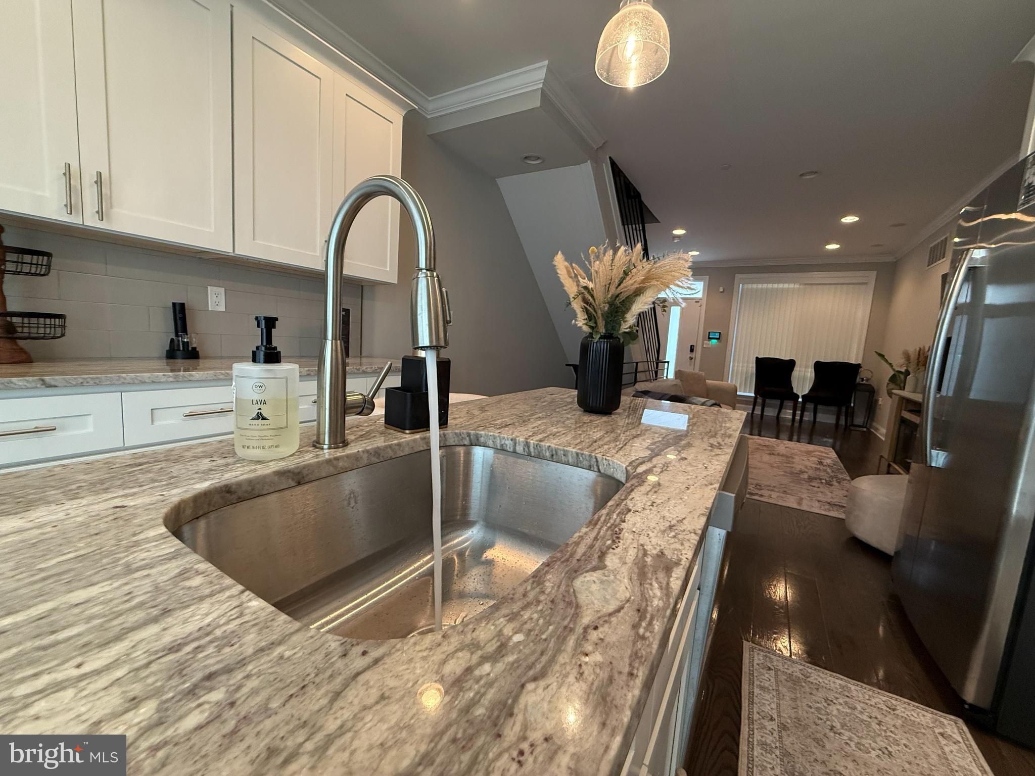 2131 North 10th Street Philadelphia, PA 19122 - Photo 6 of 18 a view of kitchen island with stainless steel appliances granite countertop sink and stove