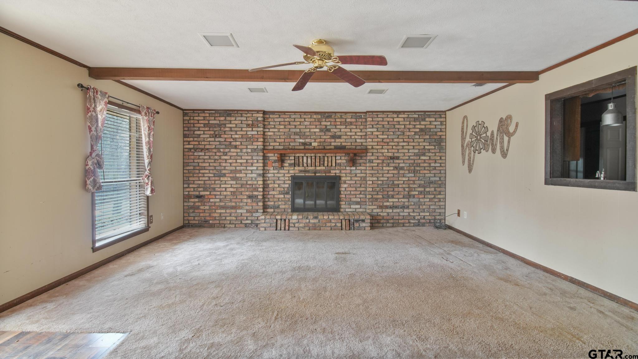 130 Golfcrest Drive Rusk, TX 75785 - Photo 20 of 23 an empty room with fireplace and fan