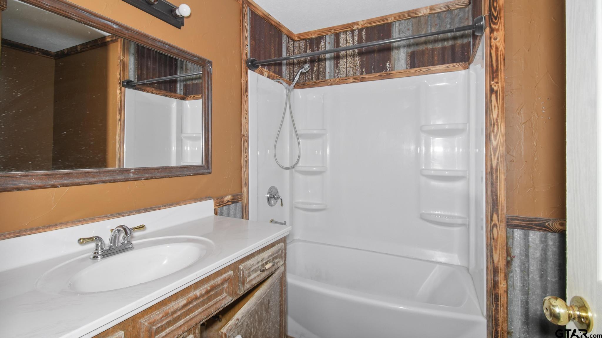130 Golfcrest Drive Rusk, TX 75785 - Photo 8 of 23 a bathroom with a granite countertop sink and a mirror