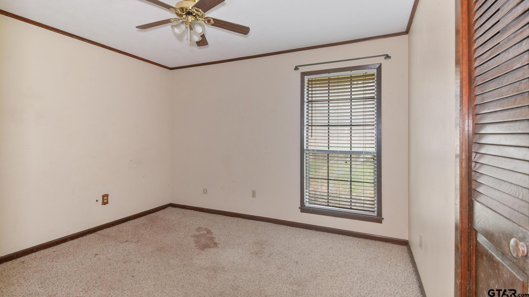 130 Golfcrest Drive Rusk, TX 75785 - Photo 9 of 23 an empty room with windows and fan