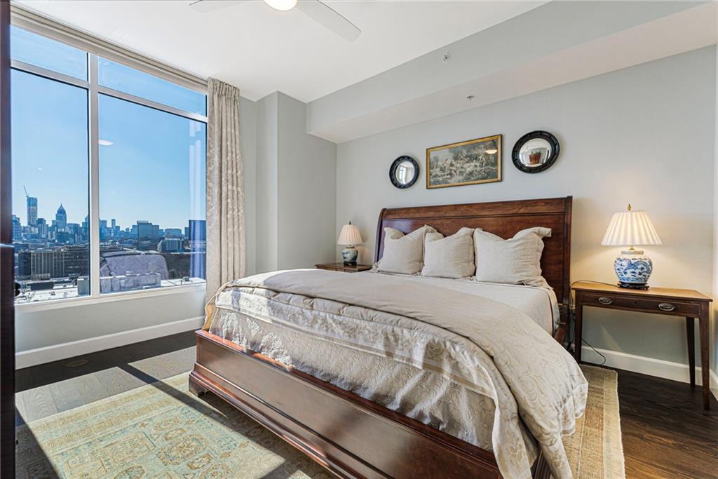 1820 Peachtree Road Northwest, Unit 1510 Atlanta, GA 30309 - Photo 22 of 75 a bedroom with a bed and a lamp on table