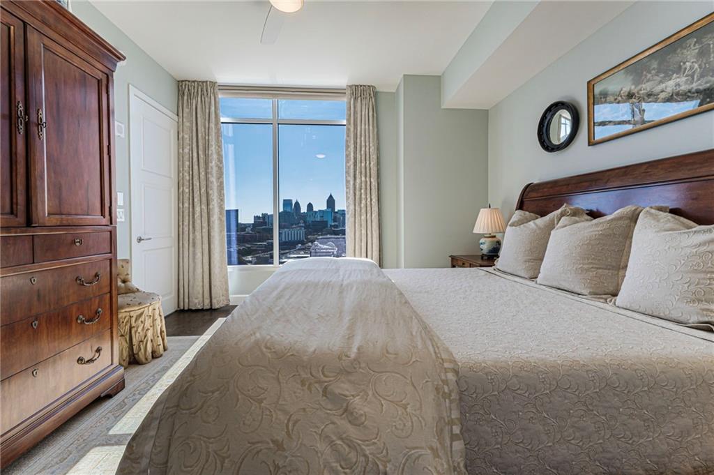 1820 Peachtree Road Northwest, Unit 1510 Atlanta, GA 30309 - Photo 23 of 75 a bedroom with a large bed and a large mirror