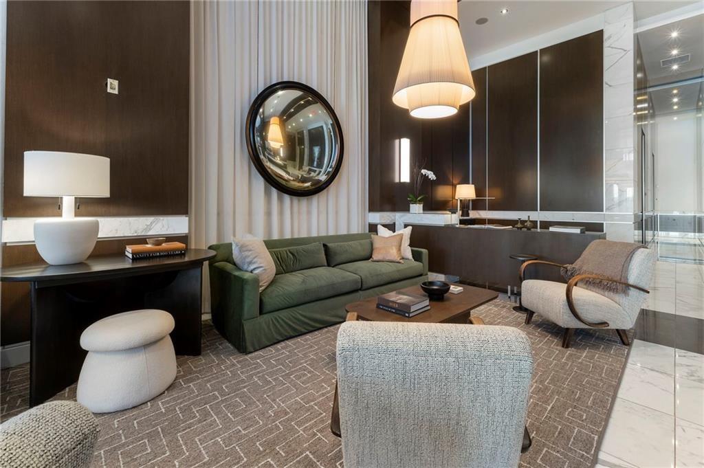 1820 Peachtree Road Northwest, Unit 1510 Atlanta, GA 30309 - Photo 62 of 75 a living room with furniture a mirror and a lamp