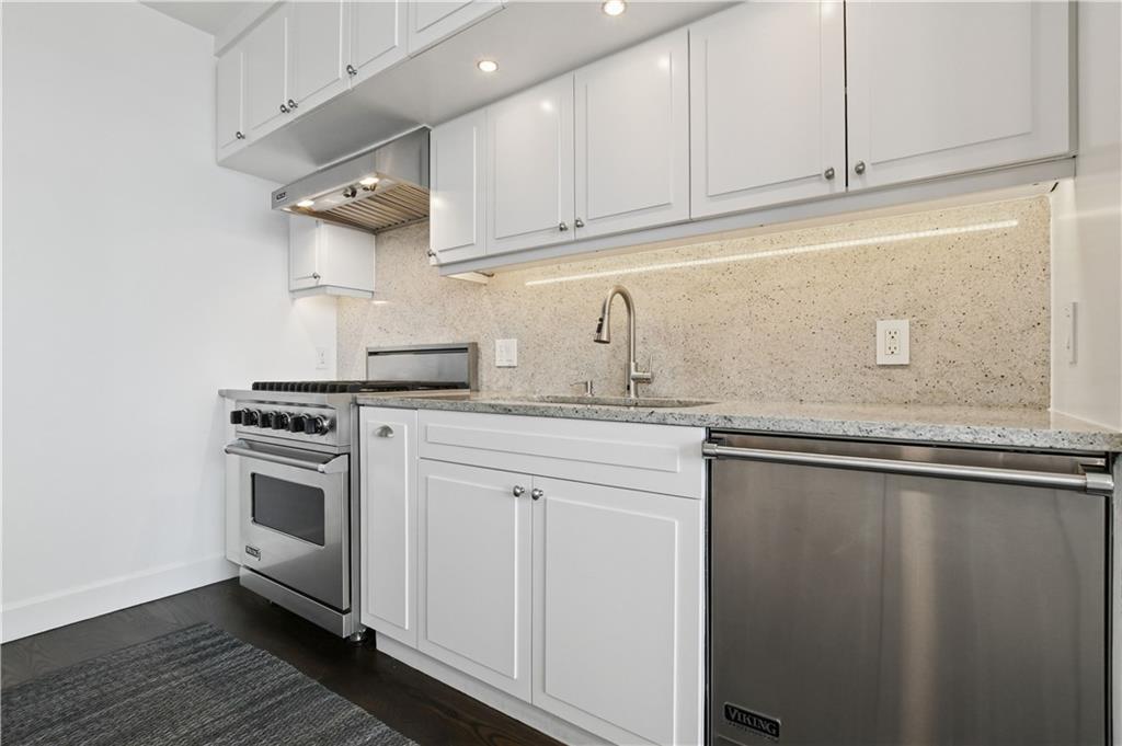 1820 Peachtree Road Northwest, Unit 1510 Atlanta, GA 30309 - Photo 10 of 75 a kitchen with stainless steel appliances granite countertop a sink a stove and cabinets