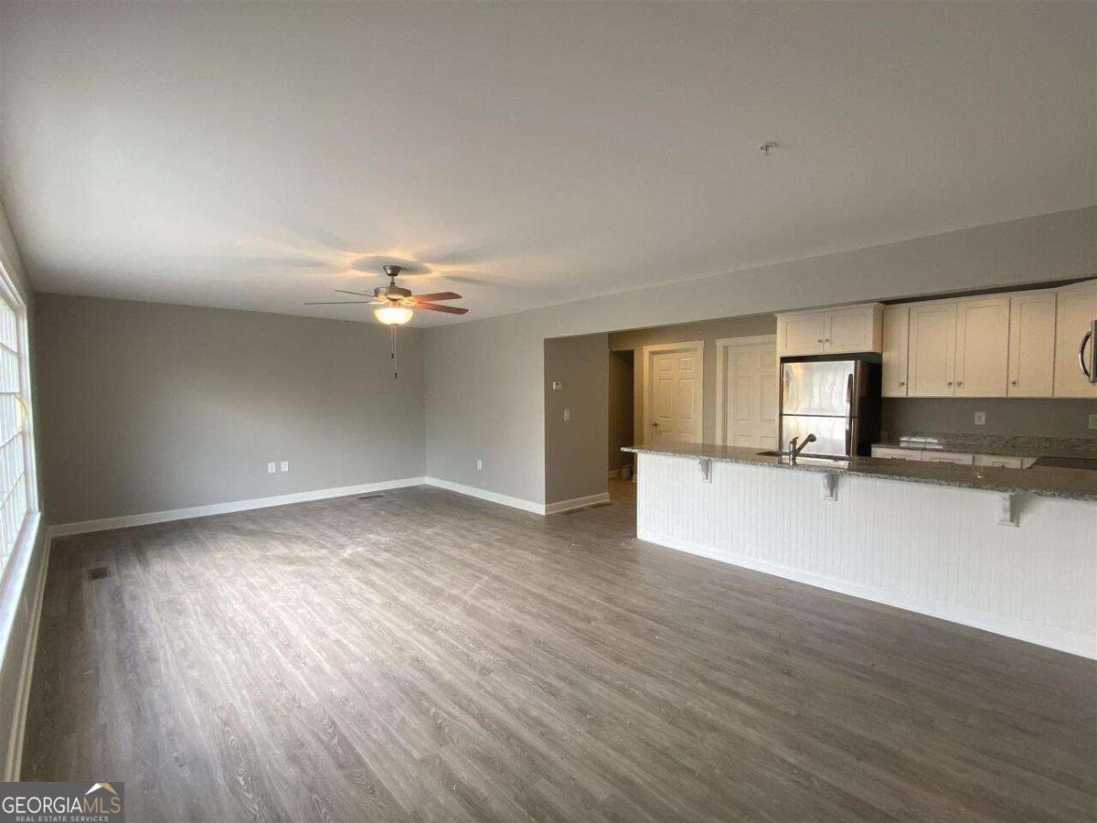 95 North Jackson Street, Unit 4 Hartwell, GA 30643 - Photo 2 of 8 a view of a kitchen with wooden floor and a ceiling fan