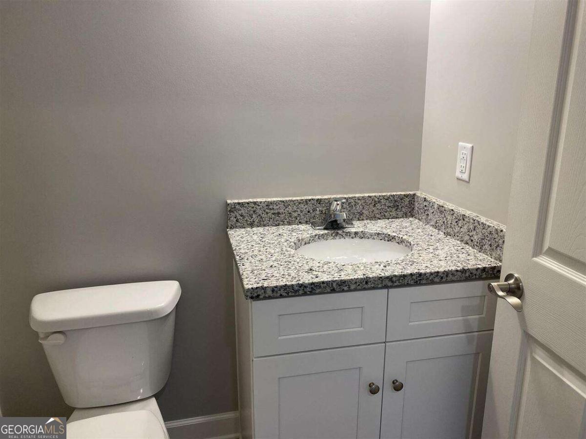 95 North Jackson Street, Unit 4 Hartwell, GA 30643 - Photo 7 of 8 a bathroom with a granite countertop toilet and sink