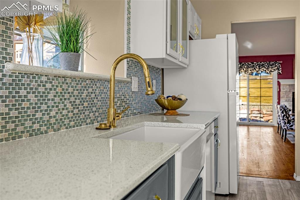 1310 Bison Ridge Drive Colorado Springs, CO 80919 - Photo 11 of 45 a kitchen with a sink a counter and a view of living room