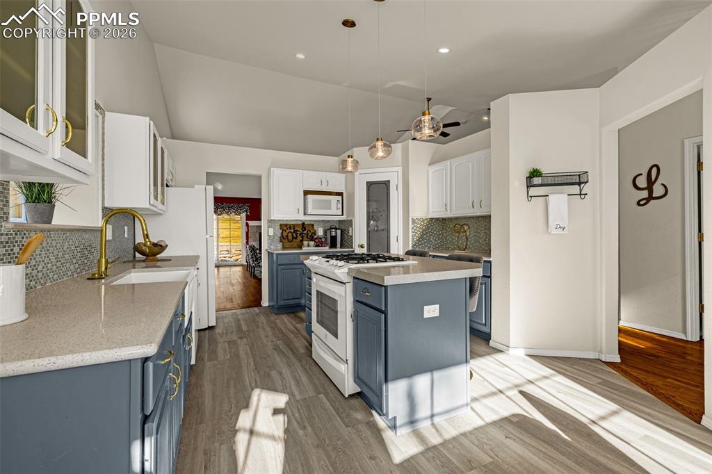 1310 Bison Ridge Drive Colorado Springs, CO 80919 - Photo 12 of 45 a large kitchen with stainless steel appliances sink refrigerator and cabinets